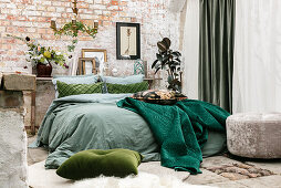Vintage-style bedroom with brick wall and green accents
