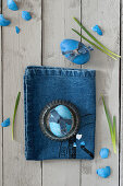 Blue Easter egg decorated with denim ribbon
