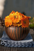 Posy of pot marigolds in rounded vase