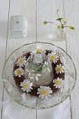 Wreath of anemones in cut glass bowl with glass cover