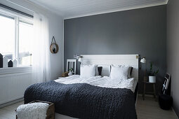 Simple bedroom in grey and white with board headboard