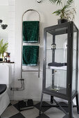 Grey display cabinet and heated towel rail in classic bathroom