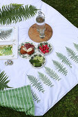 Snacks on handmade picnic blanket with fern motifs