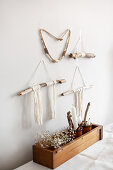 Bohemian-style wall hanging made from sticks and woollen yarn