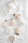 Handmade tassels, paper rosettes and wrapped gift