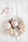White, handmade tassels and Christmas-tree baubles