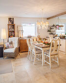 Festively set dining table in open-plan, country-house-style interior