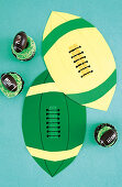 Cupcakes and paper decorations for rugby-themed party