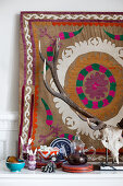Hunting trophy in front of ethnic-style wall hanging