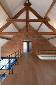 Gallery level in converted barn with brick wall