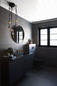 Modern, masculine bathroom decorated in black with golden accents