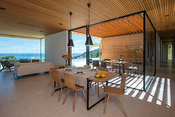 Dining table in open-plan interior of modern, architect-designed house