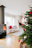 Christmas tree and wood-burning stove in modern living room