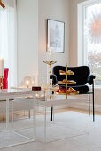 Cake stand and candles on coffee table in modern living room