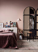 Wardrobe with arch and wickerwork in the bedroom all in antique pink