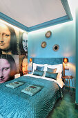 Petrol-blue bedroom with Mona Lisa wallpaper on wall next to bed
