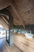 Wooden washstand in ensuite bathroom with view into bedroom