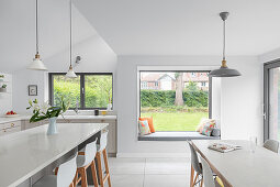 Modern kitchen-dining room with window seat overlooking garden