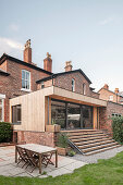 Terrace outside brick house with modern extension