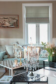 Lit candles in elegant candelabra on coffee table