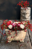 Arrangement of rose hips and everlasting flowers