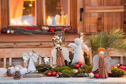 Wintry arrangement of handmade angels and natural materials