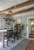 A long dining table with chairs in a rural-style dining room