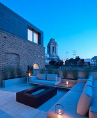 Modern lounge furniture and gas fireplace on roof terrace