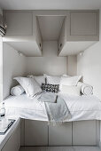 Recessed bed with built in storage, bolsters and cushions