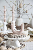 Artistically twisted and curved candles on table set for Easter meal