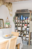 Old shelving unit with nostalgic crockery in a Mediterranean dining room