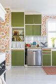 Retro kitchen with green cabinets, floral wallpaper and white floor