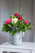 Bouquet of carnations, roses and gaultheria leaves