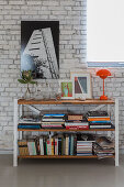 Bookcase against white-painted brick wall