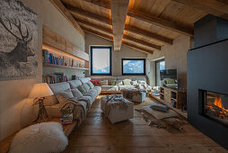 Comfortable sofa set below wooden shelves in living room with wooden floor and wooden ceiling