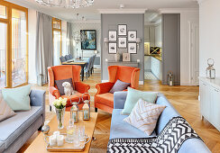 Orange armchairs in elegant, open-plan, classic interior