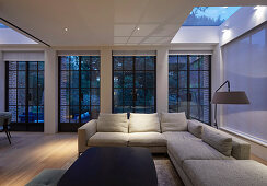 Living room with lattice windows and skylights at twilight