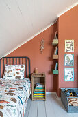 Bed linen with animal motif on children's bed in the attic room