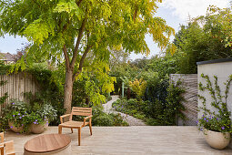 Chair on terrace and view of garden with gravel patch
