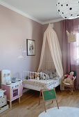 Metal bed with canopy in girl's bedroom