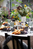 Set table with autumnal decor in garden