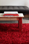 Vintage wooden table in red rug
