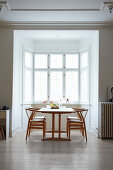Dining table and classic chair in window bay