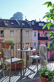 Bistro table with two chairs on the balcony, view of the neighboring building