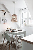 White table set for Christmas, bamboo pendant lamp above it