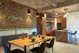 Dining area next to brick wall in loft apartment