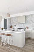 Island counter and bar stools in modern kitchen in shades of grey