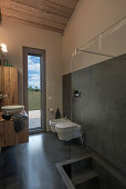 Bathroom with wood, concrete and glass elements