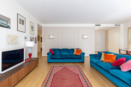 Blue upholstered sofas and TV cabinet in the living room