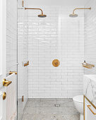 Shower area with two shower heads and white wall tiles